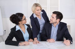 Group of a professional business team sitting at the table talking together. stock photos Group of a professional business team sitting at the table talking together. stock photos