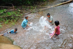 Group of rural children playing in water together stock photo Group of rural children playing in water together stock photo