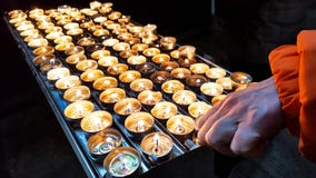 Group of shiny fire burning candles on an metal holder stock image Group of shiny fire burning candles on an metal holder stock image
