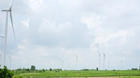 Group of wind turbines on the wind farm field. Electricity production industry, sustainable clean energy, environment conservation
