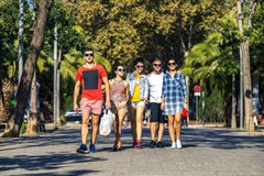Group of young and attractive people is going along the alley. royalty free stock photo Group of young and attractive people is going along the alley. royalty free stock photo