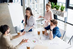 Group of young business people discussing new project on small business meeting Royalty Free Stock Photo Group of young business people discussing new project on small business meeting Royalty Free Stock Photo