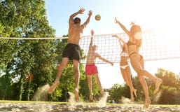 Group young Friends Playing Volleyball On Beach stock photos Group young Friends Playing Volleyball On Beach stock photos