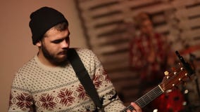 Group of young male musicians playing in garage stock video footage Group of young male musicians playing in garage stock video footage