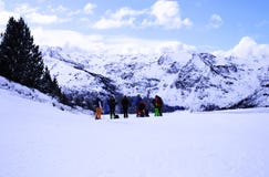 A group of young skiers in the mountains admire the winter mountain scenery Stock Photo A group of young skiers in the mountains admire the winter mountain scenery Stock Photo