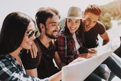 Group of Young Smiling People Holding Paper Map royalty free stock image Group of Young Smiling People Holding Paper Map royalty free stock image