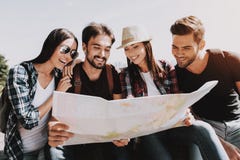 Group of Young Smiling People Holding Paper Map royalty free stock photography Group of Young Smiling People Holding Paper Map royalty free stock photography