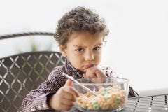 Grumpy child disappointed with his breakfast Royalty Free Stock Photography Grumpy child disappointed with his breakfast Royalty Free Stock Photography