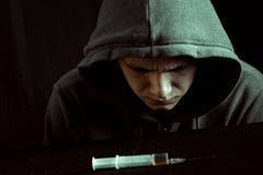 Grunge Image Of A Depressed Drug Addict Looking At A Syringe And Drugs Royalty Free Stock Photo Grunge Image Of A Depressed Drug Addict Looking At A Syringe And Drugs Royalty Free Stock Photo