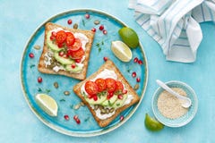 Grzanki z feta serem, pomidorami, avocado, granatowem, dyniowymi ziarnami i flaxseed flancami, Diety śniadaniowy Wyśmienicie, zdr fotografia royalty free Grzanki z feta serem, pomidorami, avocado, granatowem, dyniowymi ziarnami i flaxseed flancami, Diety śniadaniowy Wyśmienicie, zdr fotografia royalty free