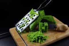 Grüner Pestokäse auf einem Schneidebrett mit einer Käsereibe stockbilder Grüner Pestokäse auf einem Schneidebrett mit einer Käsereibe stockbilder