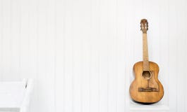 Guitar on a white chair and white background stock photos Guitar on a white chair and white background stock photos