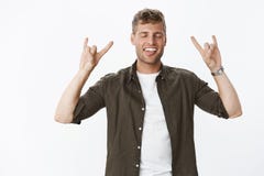 Guy rocking, feeling cool and awesome showing rock-n-roll gesture close eyes and stick tongue excited and carefree royalty free stock photos Guy rocking, feeling cool and awesome showing rock-n-roll gesture close eyes and stick tongue excited and carefree royalty free stock photos
