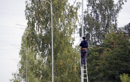 The guy on the stairs climbed on the pole stock photos The guy on the stairs climbed on the pole stock photos