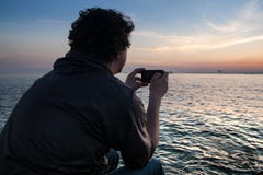 Guy takes on the phone a beautiful view sunset in the Bosphorus Strait. Istanbul royalty free stock images Guy takes on the phone a beautiful view sunset in the Bosphorus Strait. Istanbul royalty free stock images