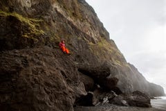 Guy tourist sits on top of a mountain in Iceland, the concept of royalty free stock image Guy tourist sits on top of a mountain in Iceland, the concept of royalty free stock image