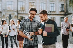 Guys. Books. Standing in University. Good Mood stock photo Guys. Books. Standing in University. Good Mood stock photo