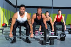 Gym group with weight lifting bar crossfit workout