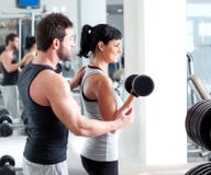 Gym woman personal trainer with weight training