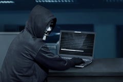 Hacker Man Wearing Mask Using Laptop To Upload Computer Virus Royalty Free Stock Images