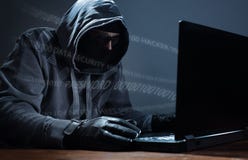 Hacker stealing data from a laptop