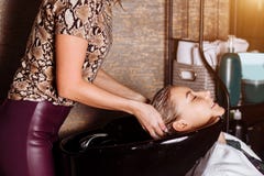 Beautiful woman washing hair in a hair salon stock photo Beautiful woman washing hair in a hair salon stock photo