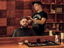 Hairstyle process in a man's Barbershop stock photos Hairstyle process in a man's Barbershop stock photos