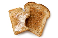Half eaten buttered slice of whole wheat toast and whole dry sli Stock Photos Half eaten buttered slice of whole wheat toast and whole dry sli Stock Photos