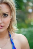 Half face of blond woman walking in summer forest stock photography Half face of blond woman walking in summer forest stock photography