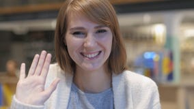 Hallo, junge Frauen-wellenartig bewegende Hand zum Willkommen im Café lizenzfreies stockfoto Hallo, junge Frauen-wellenartig bewegende Hand zum Willkommen im Café lizenzfreies stockfoto