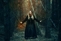 Halloween. beautiful girl with a lantern in a black dress in the forest. stock photography Halloween. beautiful girl with a lantern in a black dress in the forest. stock photography