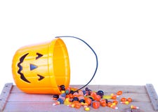 Halloween candy and pumpkin bucket on wood stock images Halloween candy and pumpkin bucket on wood stock images
