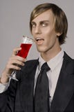 Halloween Death is on its way!. Handsome young vampire drinking form Champaign glass stock image Halloween Death is on its way!. Handsome young vampire drinking form Champaign glass stock image