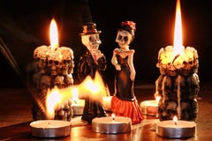 Halloween: figures of two skeletons of the man and the woman against the background of the burning candles in the form Stock Photography Halloween: figures of two skeletons of the man and the woman against the background of the burning candles in the form Stock Photography