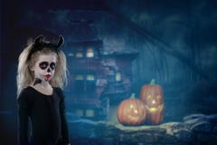 Halloween, Holidays, Masquerade Concept - The Portrait Of Young Little Beautiful Girl With Skull Makeup And Horns. Halloween, Face Stock Photo Halloween, Holidays, Masquerade Concept - The Portrait Of Young Little Beautiful Girl With Skull Makeup And Horns. Halloween, Face Stock Photo