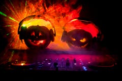 Halloween Pumpkin On A Dj Table With Headphones On Dark Background With Copy Space. Happy Halloween Festival Decorations And Music Royalty Free Stock Images Halloween Pumpkin On A Dj Table With Headphones On Dark Background With Copy Space. Happy Halloween Festival Decorations And Music Royalty Free Stock Images