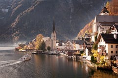 Hallstatt, Austria. Beautiful town of Hallstatt in Austria at sunset reflecting in mountain lake Hallstatt, Austria. Beautiful town of Hallstatt in Austria at sunset reflecting in mountain lake