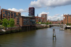 HAMBURG, GERMANY - JULY 18, 2015: ferry on the canal of Historic Speicherstadt houses and bridges at evening with amaising skyview royalty free stock photos HAMBURG, GERMANY - JULY 18, 2015: ferry on the canal of Historic Speicherstadt houses and bridges at evening with amaising skyview royalty free stock photos