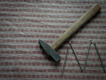 Hammer with nails on brown wood table stock photos Hammer with nails on brown wood table stock photos