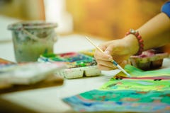 Hand of artist with brush painting picture stock photos Hand of artist with brush painting picture stock photos