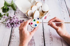 Hand decorating gingerbread colorful cookies on wooden background. Top View stock photography Hand decorating gingerbread colorful cookies on wooden background. Top View stock photography