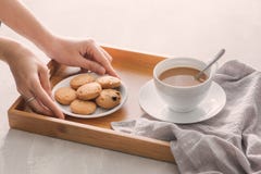 Hand die koekjes op plaat zetten in dienblad Ontbijtconcept met royalty-vrije stock fotografie Hand die koekjes op plaat zetten in dienblad Ontbijtconcept met royalty-vrije stock fotografie