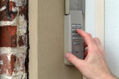 hand entering code on keypad - garage door opener - home security stock photo hand entering code on keypad - garage door opener - home security stock photo