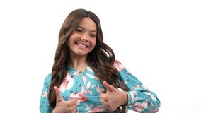 hand gesture of thumb up showing happy kid girl with long curly hair looking approvingly, super.