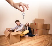 Hand giving a key young couple stock photography Hand giving a key young couple stock photography