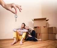 Hand giving a key young couple stock photo Hand giving a key young couple stock photo