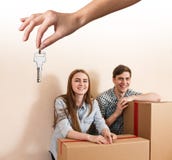 Hand giving a key young couple royalty free stock photography Hand giving a key young couple royalty free stock photography