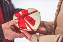 Hand of guy giving his girlfriend Christmas present close up royalty free stock photo Hand of guy giving his girlfriend Christmas present close up royalty free stock photo
