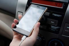 Hand hold smartphone in car,Charger plug phone on car royalty free stock images Hand hold smartphone in car,Charger plug phone on car royalty free stock images