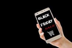 Hand holding cellphone with black friday text on black background. royalty free stock images Hand holding cellphone with black friday text on black background. royalty free stock images